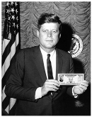 President John F. Kennedy holds a U.S. Savings Bond